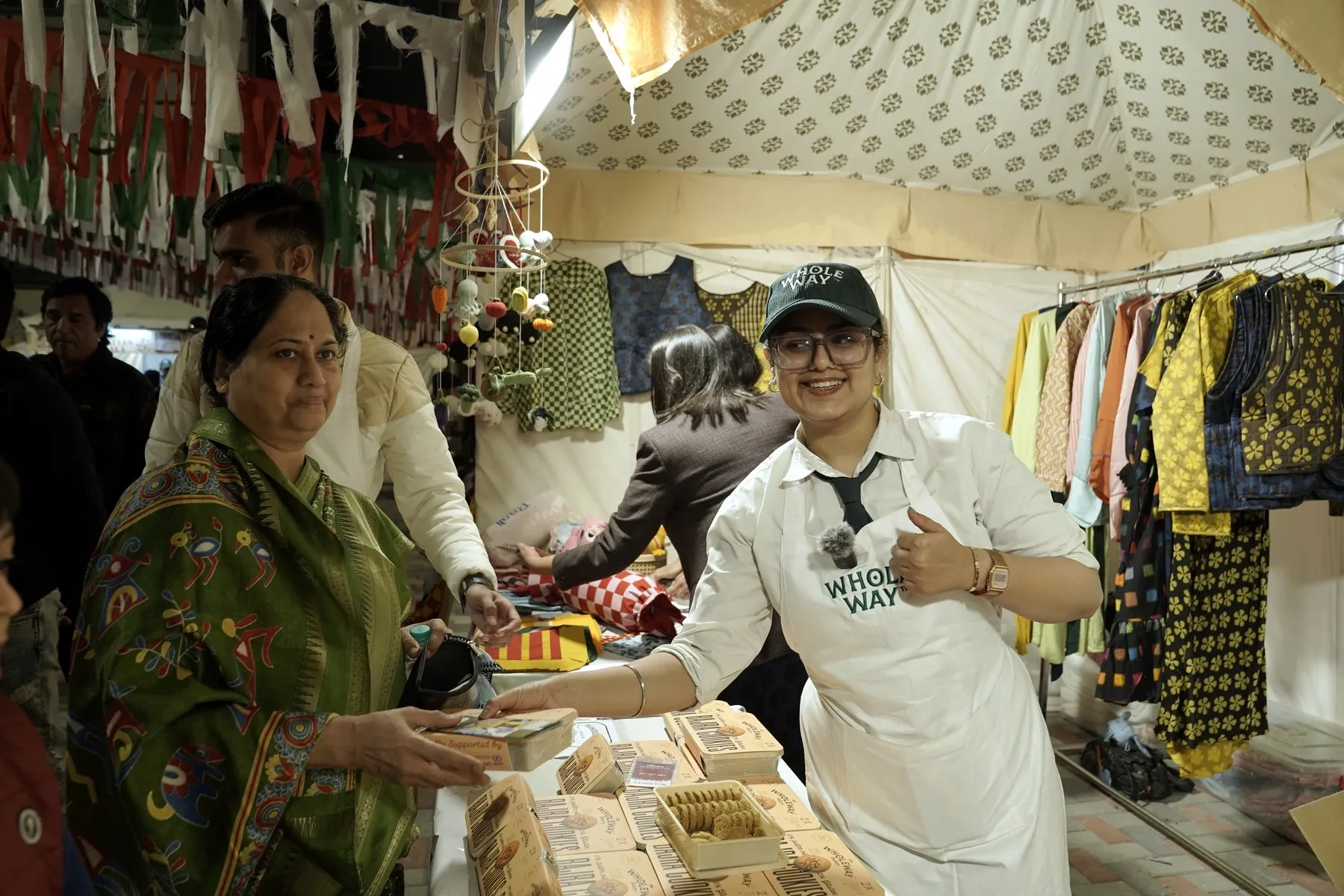 A Wholeway team member serving cookies to festival visitors